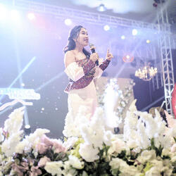 A woman delivering a speech at the Jally Ventures Grand Ball 2023 A woman speaking on stage during the Jally Ventures Grand Ball 2023.